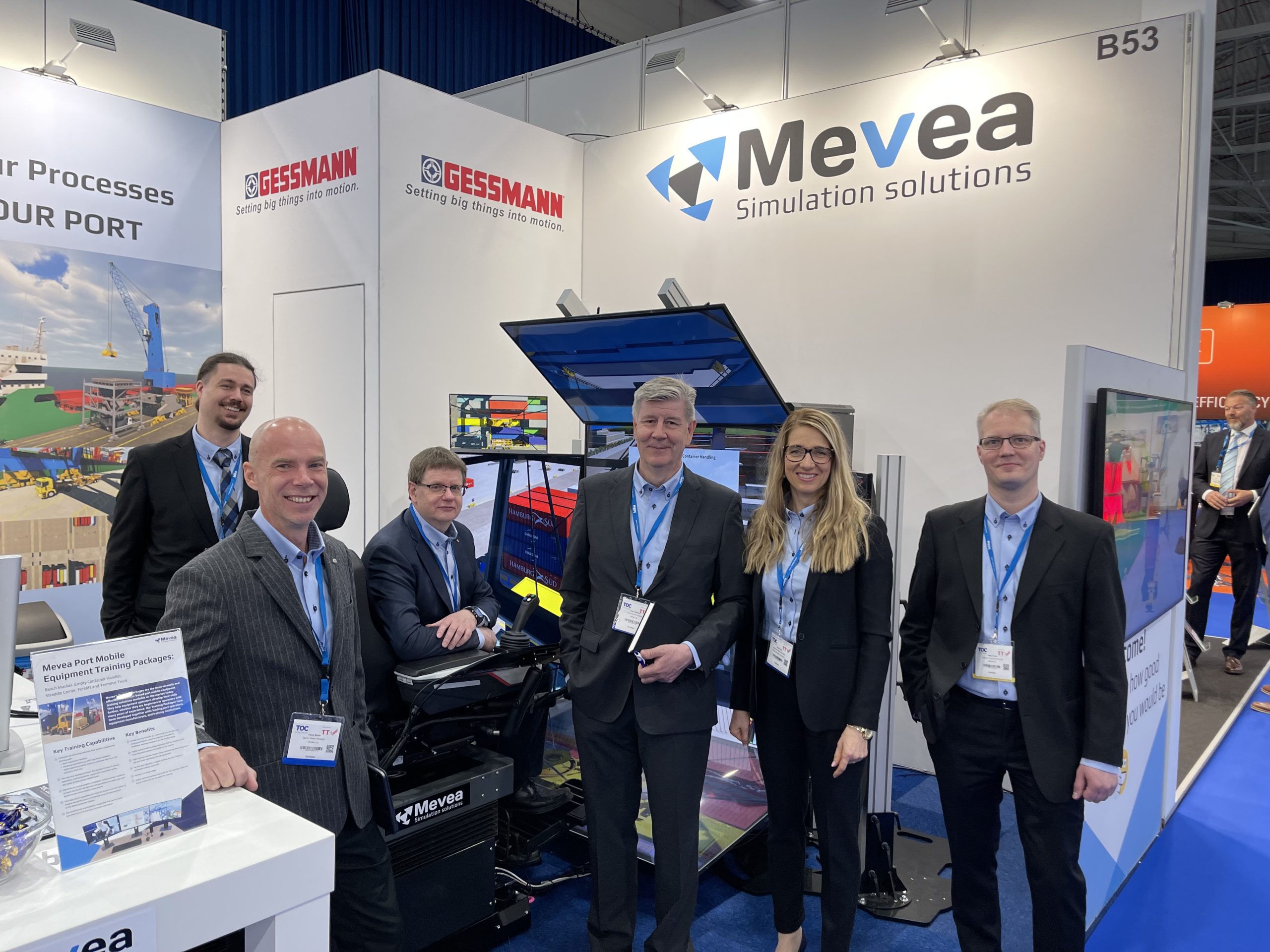 Members of mevea team standing infront of the simulator at the exhibition stand.
